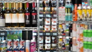 Beer cans are stacked as props in front a display of ice cream, at a press availability attended by Ontario Premier Doug Ford at a convenience store in Toronto, Thursday, Dec. 14, 2023. The Ontario Government announced that in 2026 they will allow sales of beer, wine, cider, coolers and pre-mixed drinks to be sold at convenience stores, grocery stores and "big box" retailers. THE CANADIAN PRESS/Chris Young