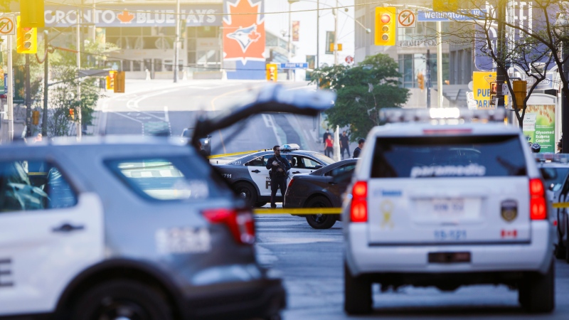 Toronto Police work the scene of a shooting in downtown Toronto, Tuesday, May 26, 2020. THE CANADIAN PRESS/Cole Burston