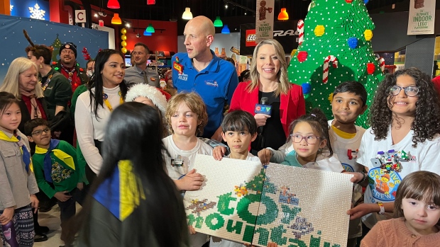 Young donors poses with Lyndsay Morrison as part of the Toy Mountain campaign at Legoland Discovery Centre on Dec. 7, 2023. (Farah Chandani/CTV News Toronto)