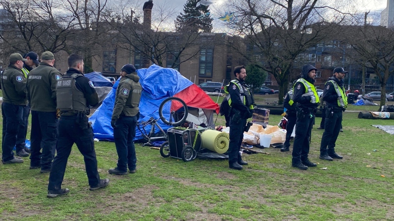 Park rangers and police stand by a tent in Oppenheimer Park on Tuesday, Jan. 8. 