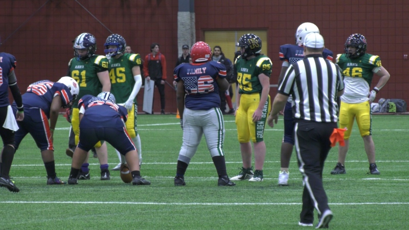 A team from Alberta takes on the team from Boston at the Battle of the Prairies tackle football tournament in Moose Jaw. (Brit Dort / CTV News) 