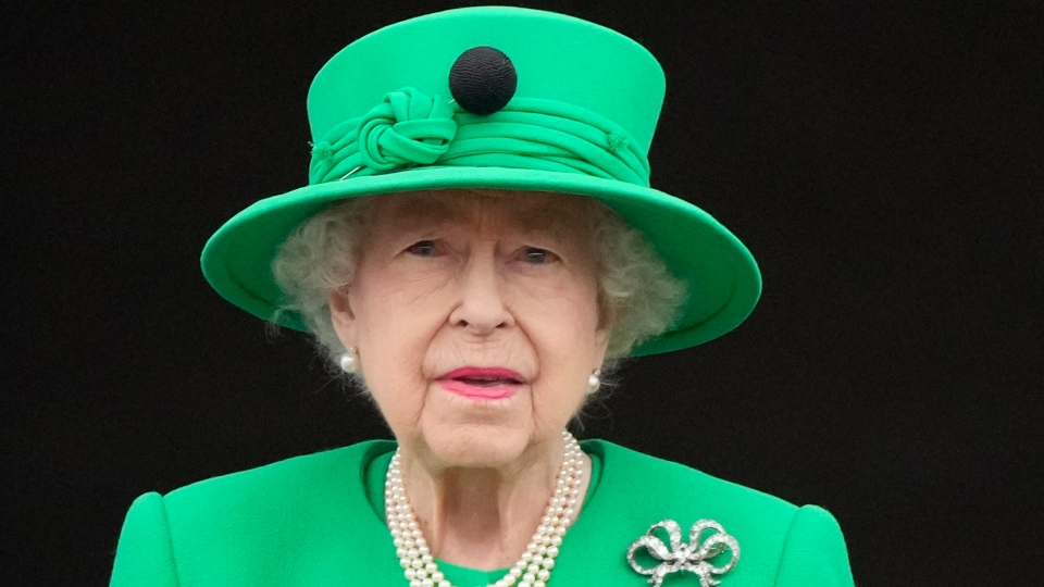 Queen Elizabeth II stands on the balcony