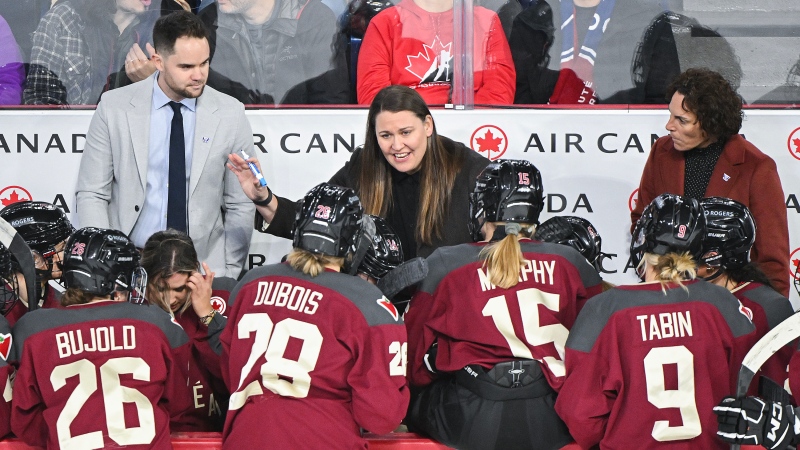 Montreal head coach Kori Cheverie, centre, talks with players during first period PWHL hockey action against New York in Laval, Que., Tuesday, January 16, 2024. THE CANADIAN PRESS/Graham Hughes