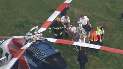Paramedics load fatally wounded Lisa Dudley into a helicopter outside her home in Mission, B.C. Sept. 22, 2008. (CTV)