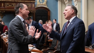 Quebec Premier Francois Legault, right, speaks with Quebec Finance Minister Eric Girard before question period, Thursday, December 7, 2023 at the legislature in Quebec City. THE CANADIAN PRESS/Jacques Boissinot