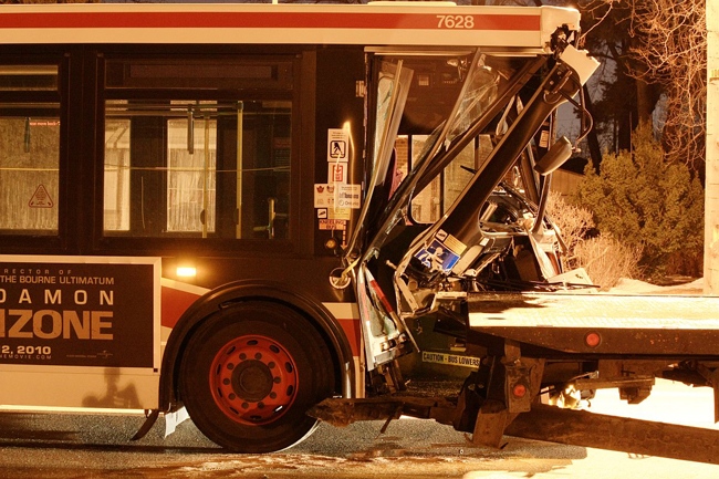A TTC bus crashed into a parked flatbed truck on Morningside Avenue, late Wednesday, March 4, 2010. (Tom Stefanac / CTV News)