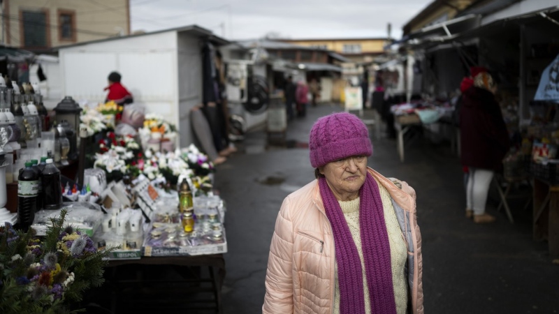 An ethnic Hungarian woman leaves the market in downtown Berehevo, Saturday, Jan. 27, 2024. (AP Photo/Denes Erdos)
