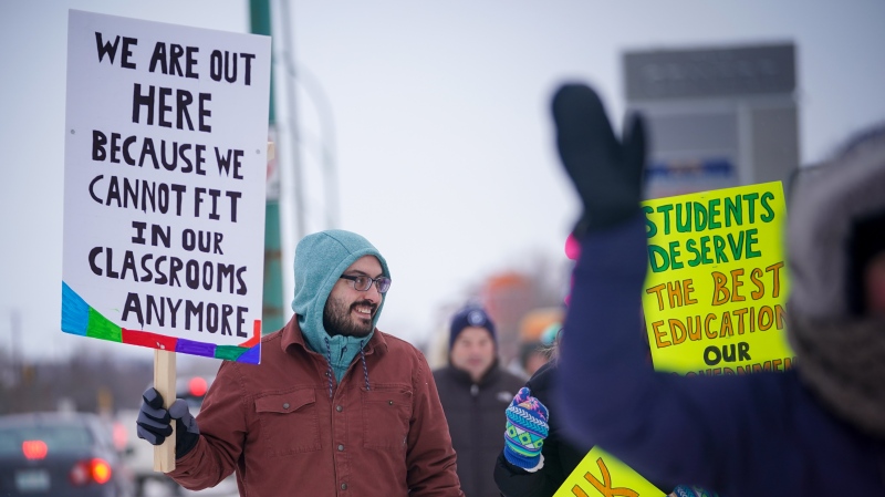 A person holds a sign during a province-wide, one-day strike organized by the members of Saskatchewan Teachers’ Federation in Saskatoon, Sask., on Monday, January 22, 2024. THE CANADIAN PRESS/Heywood Yu
