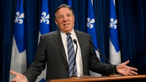 Quebec Premier Francois Legault gestures as he announces his decision to stop accepting private funding, Thursday, Feb. 1, 2024 at the legislature in Quebec City. THE CANADIAN PRESS/Jacques Boissinot