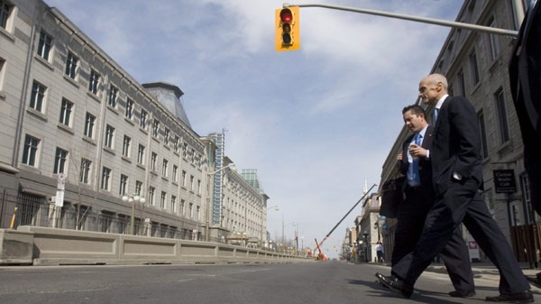 The concrete barricades outside the United States embassy are visible in this file photo of then-U.S. Homeland Security Secretary Michael Chertoff taking in the sights during a visit to Ottawa on Wednesday April 9, 2008. (THE CANADIAN PRESS/Tom Hanson)