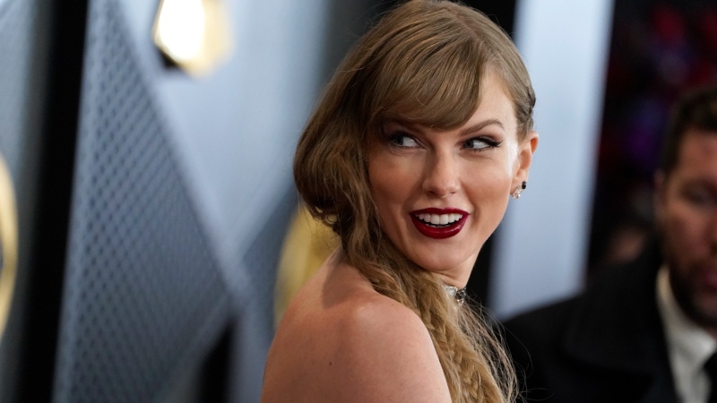 Taylor Swift wins album of the year at the Grammy Awards for the fourth time, setting a new record