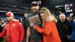 FILE - Kansas City Chiefs tight end Travis Kelce walks with Taylor Swift following the AFC Championship NFL football game between the Baltimore Ravens and the Kansas City Chiefs, Sunday, Jan. 28, 2024, in Baltimore. (AP Photo/Julio Cortez, File)