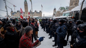 Police move in to clear downtown Ottawa near Parliament hill of protesters after weeks of demonstrations on Saturday, Feb. 19, 2022. THE CANADIAN PRESS/Cole Burston 