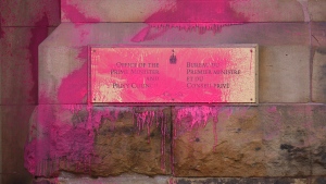 Pink paint covers a sign on the entrance to the prime minister's office on Wellington Street in Ottawa on Wednesday, Feb.7, 2024. (Sean Kilpatrick/THE CANADIAN PRESS)