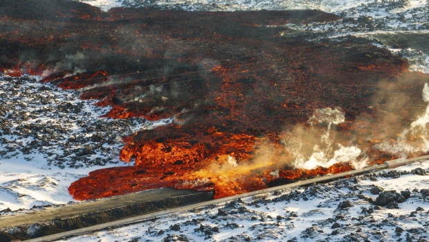 A view of lava hitting the hot water pipeline flowing on the road leading to the Blue Lagoon, in Grindavík, Iceland, Thursday, Feb. 8, 2024.<br><br>
A volcano in southwestern Iceland has erupted for the third time since December and sent jets of lava into the sky. The eruption on Thursday morning triggered the evacuation the Blue Lagoon spa which is one of the island nation’s biggest tourist attractions. (AP Photo /Marco Di Marco).