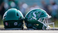 A Saskatchewan Roughriders helmet sits on the field during the first day of spring training main camp in Saskatoon, Sask., on Sunday, May 14, 2023. THE CANADIAN PRESS/Heywood Yu