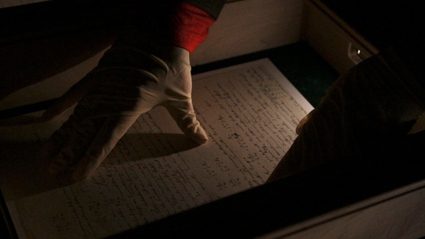 An Israeli curator positions a paper from the manuscript of Albert Einstein's general theory of relativity inside a case at the Academy of Sciences and Humanities in Jerusalem, Sunday, March 7, 2010. (AP / Tara Todras-Whitehill)