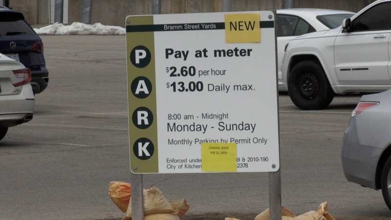 A sign advises drivers of the resumption of parking lot fees at the Bramm Street Yards lot in Kitchener. (CTV News Kitchener/Colton Wiens)