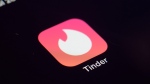 FILE - The icon for the dating app Tinder appears on a device, July 28, 2020, in New York. Tinder, Hinge and other dating apps are designed with addictive features that encourage “compulsive” use, a proposed class action lawsuit against parent company Match Group claims. (AP Photo/Patrick Sison, File)