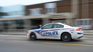 A police car drives by London Police Headquarters in London, Ont. on Monday, Jan. 29, 2024. (THE CANADIAN PRESS/Geoff Robins)