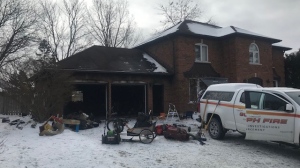 Fire investigators are pictured at the scene of a garage fire on Hands Drive in Guelph on Feb. 19, 2023. (Dave Pettitt/CTV Kitchener)