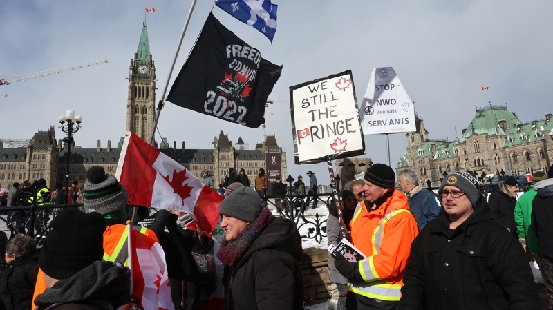 People protest on the anniversary of the police action that broke up the "Freedom Convoy" demonstrations, on Parliament Hill in Ottawa on Saturday, Feb. 17, 2024. Thousands of demonstrators took over streets around Parliament Hill in late January 2022, blocking roads with big-rig trucks and other vehicles and refusing to move. (Patrick Doyle/THE CANADIAN PRESS)