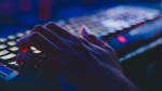 An unidentified person types on a keyboard in a darkened room. Canadian authorities said last year that LockBit was the top ransomware threat. (Pexels)