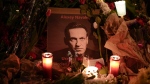 Flowers and candles are laid around a photo of Russian opposition leader Alexei Navalny during a rally to commemorate him, at Rome's Piazza del Campidoglio city council square, Monday, Feb. 19, 2024. (AP Photo/Andrew Medichini) 