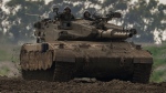 Israeli soldiers drive a tank near the Gaza Strip border, in southern Israel, Monday, Feb. 19, 2024. (AP Photo/Tsafrir Abayov)