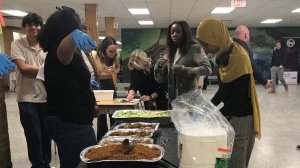 Students grab some lunch during a Ghanaian vs Nigerian jollof event at Eastwood Collegiate Institute in Kitchener on Feb. 20, 2024.  (Chris Thomson/CTV Kitchener)