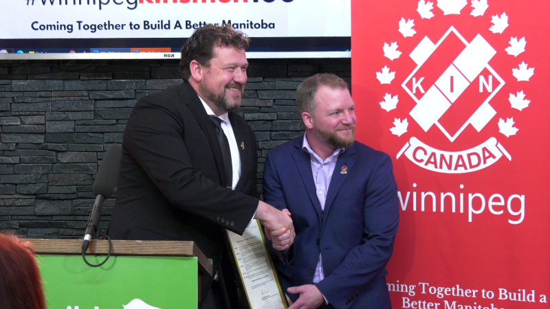 Manitoba's Minister of Sport, Culture, Heritage and Tourism Glen Simard (left) shakes hands with Kinsmen Club of Winnipeg President Christian Tardi (right) at an event celebrating the organization's 100th anniversary on Feb. 20, 2024. (Source: CTV News Winnipeg)