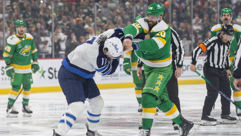 Minnesota Wild left wing Pat Maroon, right, fights Winnipeg Jets center Adam Lowry, left, during the first period of an NHL hockey game Sunday, Dec. 31, 2023, in St. Paul, Minn. (AP Photo/Bailey Hillesheim)