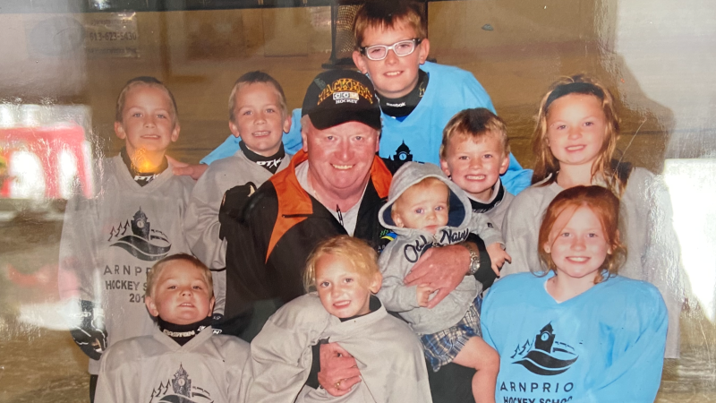 A photo in the Arthur family home in Arnprior, Ont. of Glenn Arthur and his nine grandkids. Feb. 20, 2024. (Dylan Dyson/CTV News Ottawa)