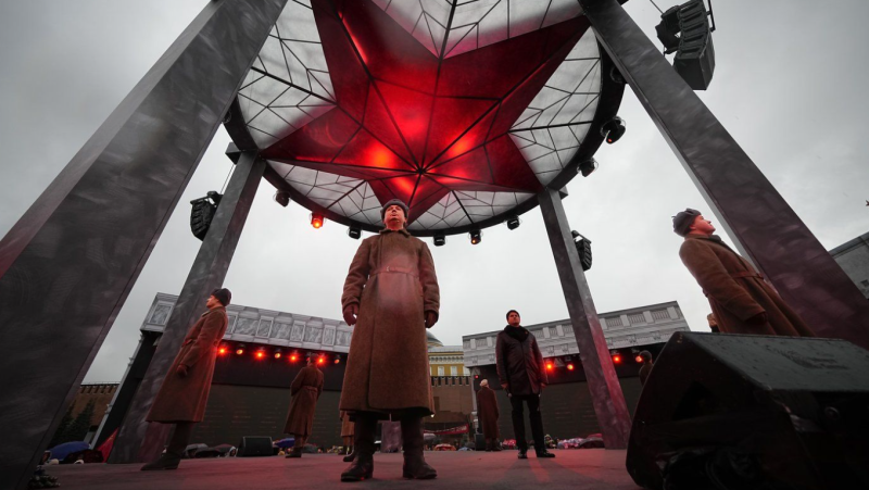 A participant dressed in Red Army World War II uniform in the role of a military traffic controller takes part in a theatrical performance at an open air interactive museum to commemorate the 82nd anniversary of the World War II-era parade, at Red Square, in Moscow, Russia, on Monday, Nov. 6, 2023. (AP Photo/Alexander Zemlianichenko, File)
