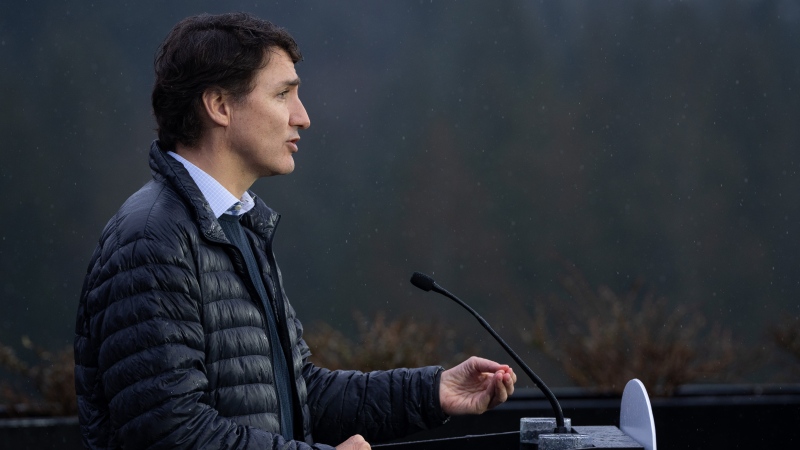 Prime Minister Justin Trudeau speaks in the rain during a news conference on housing in Vancouver on Tuesday, Feb. 20, 2024. THE CANADIAN PRESS/Ethan Cairns