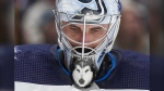Winnipeg Jets goalie Connor Hellebuyck looks on during a stoppage in play during the third period of an NHL hockey game against the Vancouver Canucks, in Vancouver, on Saturday, February 17, 2024. THE CANADIAN PRESS/Darryl Dyck 