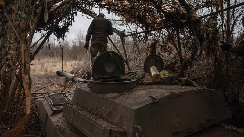 Ukrainian soldiers prepare a self-propelled artillery vehicle Gvozdika to fire towards the Russian positions on the frontline in the Donetsk region, Ukraine, Friday, Feb. 16, 2024. (Roman Chop via AP)