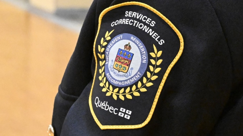 The badge of a correctional agent at a news conference, inside the Quebec Detention Centre, in Quebec City, Tuesday, Oct. 24, 2023. THE CANADIAN PRESS/Jacques Boissinot