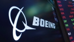  The logo for Boeing appears on a screen above a trading post on the floor of the New York Stock Exchange, July 13, 2021. (AP Photo/Richard Drew, File)
