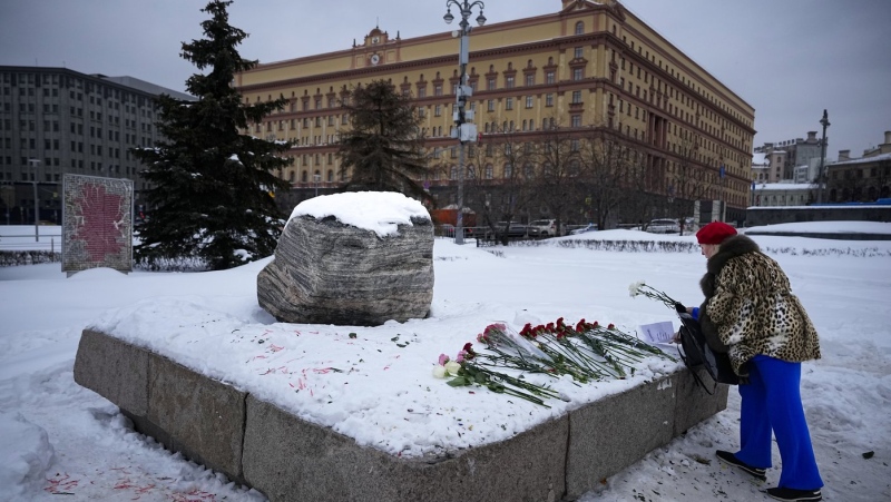 Woman lay flowers to pay tribute to Alexei Navalny at a monument outside the historical Federal Security Service building in Moscow, Wednesday, Feb. 21, 2024. Canada summoned the Kremlin's ambassador in Ottawa today to express its strong condemnation over Navalny's reported death in Russian custody. THE CANADIAN PRESS/AP-Alexander Zemlianichenko