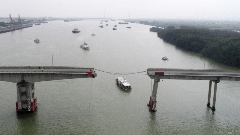 In this photo released by Xinhua News Agency, ships sail near the broken Lixinsha Bridge in Nansha District of Guangzhou, south China's Guangdong Province, Thursday, Feb. 22, 2024. (Lu Hanxin/Xinhua via AP)