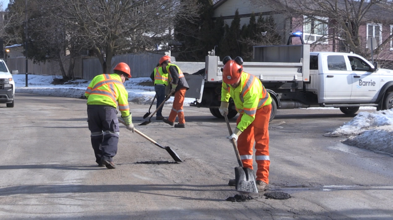 Crews work to fill potholes on a street in Barrie, Ont., on Thurs., Feb. 22, 2024. (CTV News/Rob Cooper)