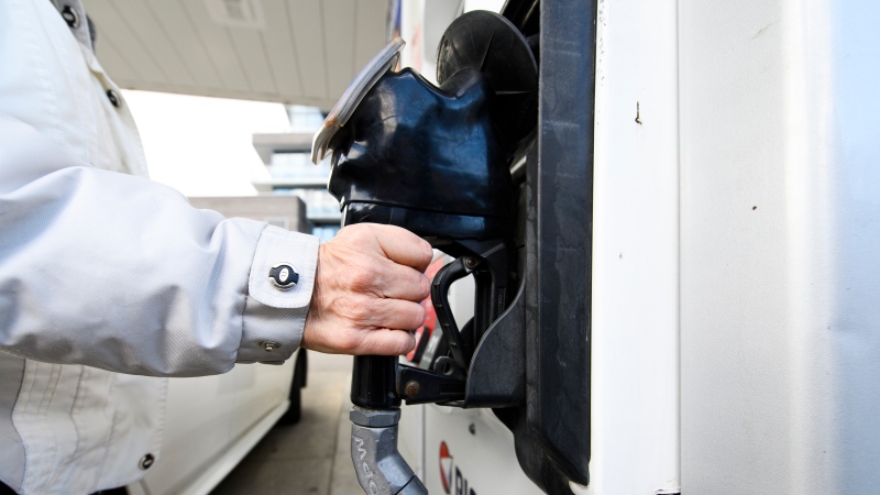 A woman gasses up at a gas station in Mississauga, Ont., Tuesday, February 13, 2024. (Source: THE CANADIAN PRESS/Christopher Katsarov)