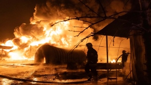 Firefighters put out the fire, at a gas station after a Russian attack on a residential neighbourhood in Kharkiv, Ukraine, Saturday, Feb. 10, 2024. (AP Photo/Yevhen Titov)