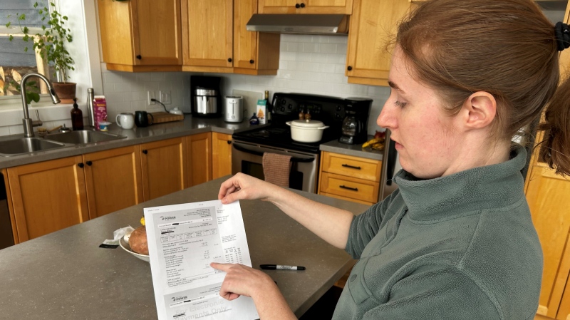 Laura Broom looks at her bill from NS Power. (CTV/Jonathan MacInnis)