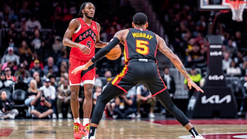 Toronto Raptors guard Immanuel Quickley (5) brings the ball down court during while being guarded by Atlanta Hawks guard Dejounte Murray (5) the first half of an NBA basketball game, Friday, Feb. 23, 2024, in Atlanta. (AP Photo/Jason Allen)