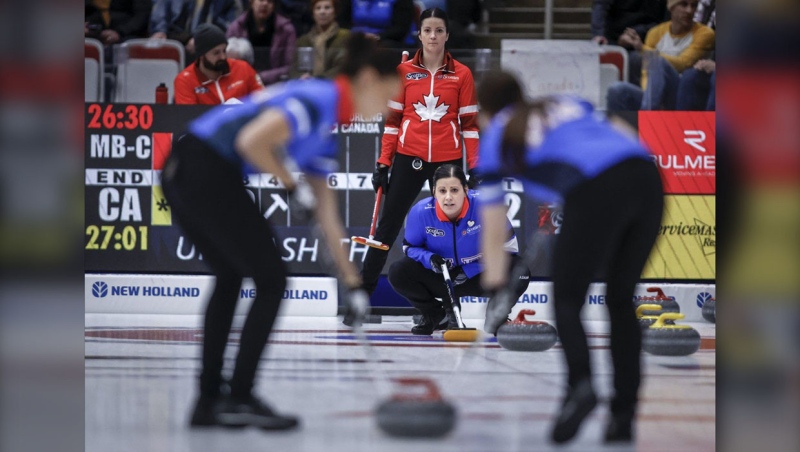 Team Manitoba-Cameron skip Kate Cameron, centre bottom, lines up a shot as Team Canada skip Kerri Einarson looks on in qualifications at the Scotties Tournament of Hearts in Calgary, Friday, Feb. 23, 2024. THE CANADIAN PRESS/Jeff McIntosh