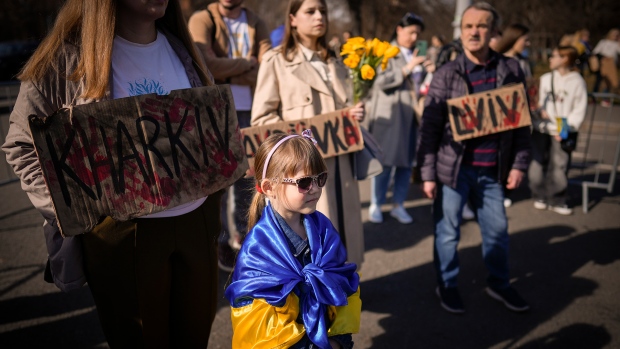 Ukrainians attend a rally outside the Victoria Palace, the Romanian government headquarters in Bucharest, Romania, Saturday, Feb. 24, 2024. (AP Photo/Andreea Alexandru)
