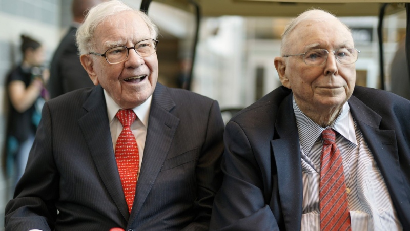 In this May 3, 2019 file photo, Berkshire Hathaway Chairman and CEO Warren Buffett, left, and Vice Chairman Charlie Munger, briefly chat with reporters before Berkshire Hathaway's annual shareholders meeting. Buffett credited his longtime partner — the late Charlie Munger — with being the architect of the Berkshire Hathaway conglomerate he’s received the credit for leading and warned shareholders in his annual letter not to listen to Wall Street pundits or financial advisors who urge them to trade often. (AP Photo/Nati Harnik, File)