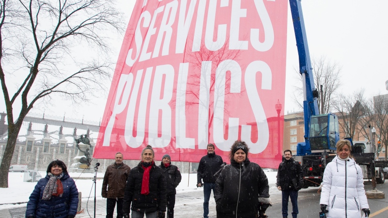 Union leaders stand in front of a banner as they demonstrate, Wednesday, November 25, 2020 in Quebec City. Eight major union leaders and workers gathered near the Quebec legislature asking the Quebec government to negotiate. From the left first row, Sonia Ethier of the CSQ,. Line Lamarre of the SPGQ, Andree Poirier of the APTS, Nancy Bedard of the FIQ, second row, Daniel Boyer of the FTQ, Sylvain Mallette of the FAE, Jacques Letourneau of the CSN and Christian Daigle of the SFPQ. (Jacques Boissinot, The Canadian Press)